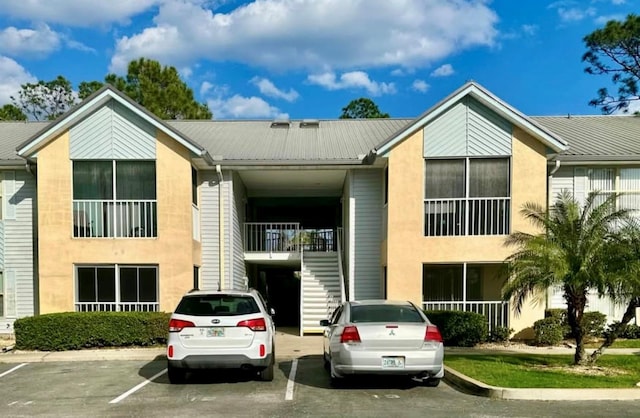 view of building exterior with uncovered parking