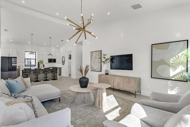 living room featuring a towering ceiling and an inviting chandelier