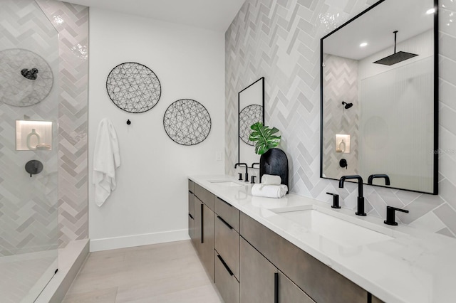 bathroom featuring vanity, tile walls, and a tile shower