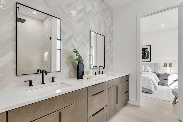 bathroom featuring vanity, hardwood / wood-style flooring, tile walls, and a shower