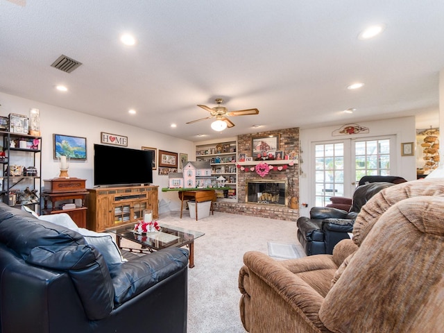 living area featuring a fireplace, carpet flooring, recessed lighting, and visible vents