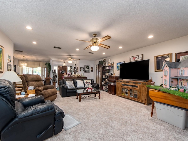 carpeted living room featuring visible vents, recessed lighting, a textured ceiling, and a ceiling fan