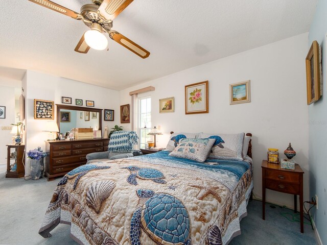 bedroom featuring baseboards, ceiling fan, a textured ceiling, and carpet