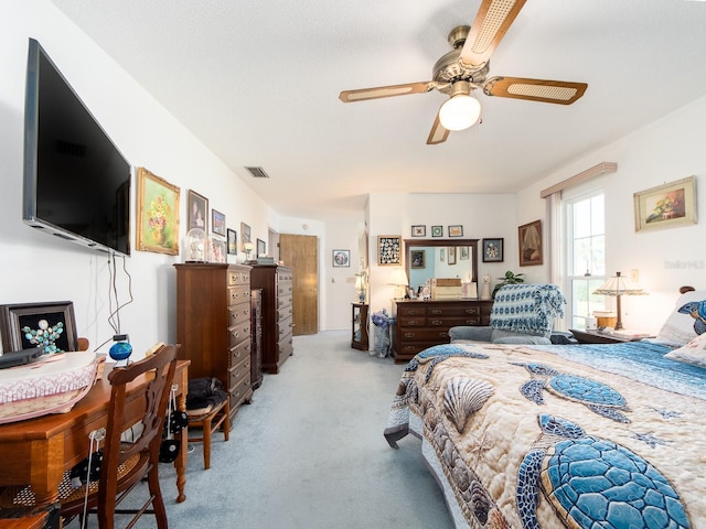 carpeted bedroom featuring visible vents and ceiling fan