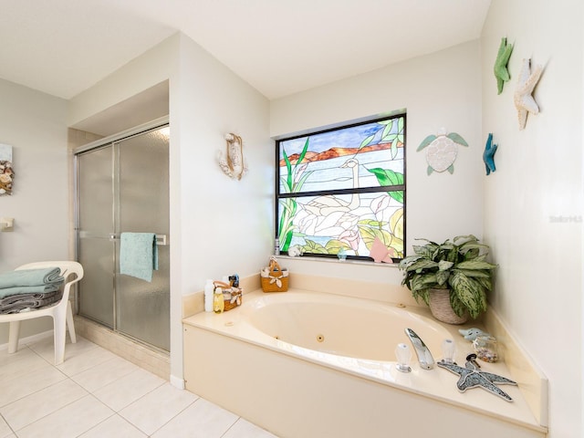 full bathroom with a whirlpool tub, a shower stall, and tile patterned flooring