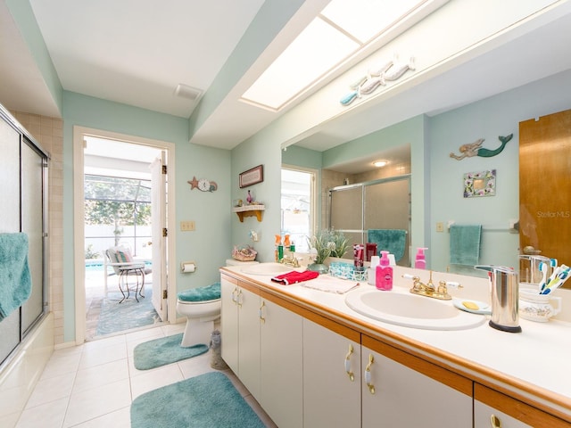 bathroom featuring plenty of natural light, a skylight, and a sink