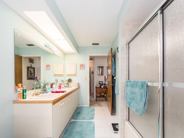 bathroom with tile patterned floors, visible vents, a stall shower, a sink, and double vanity