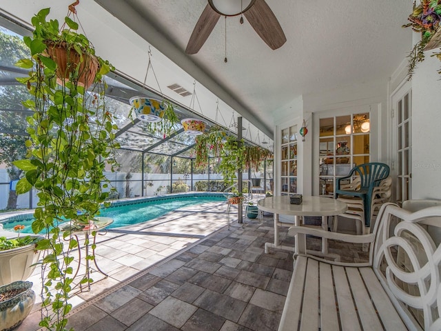 view of swimming pool with a lanai, a ceiling fan, a fenced in pool, and a patio area