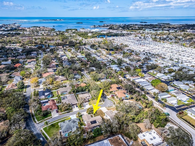 drone / aerial view featuring a residential view and a water view