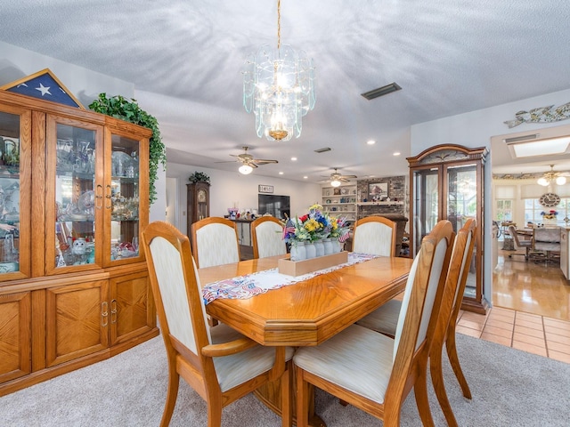 2893 Turtle Ter, Palm Harbor, FL 34683 - dining room featuring a ceiling fan, a chandelier, light tile patterned flooring, a textured ceiling, and recessed lighting