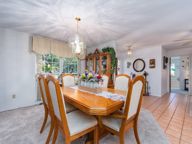 2893 Turtle Ter, Palm Harbor, FL 34683 - dining room featuring a chandelier, a textured ceiling, and light tile patterned floors