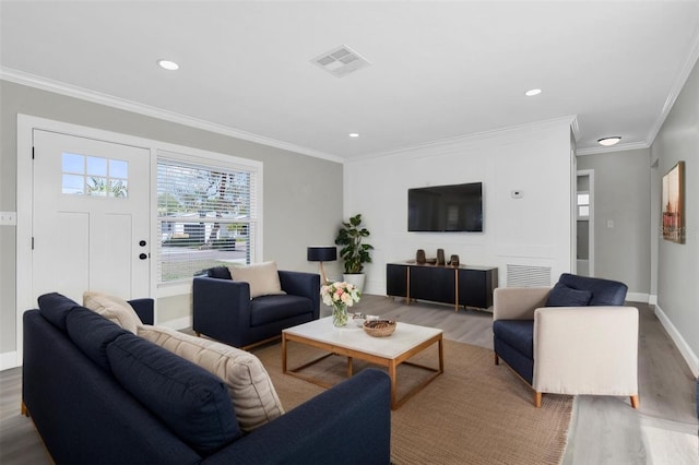 living room featuring crown molding and hardwood / wood-style flooring