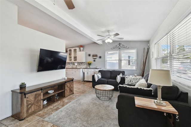 living room featuring vaulted ceiling with beams and ceiling fan