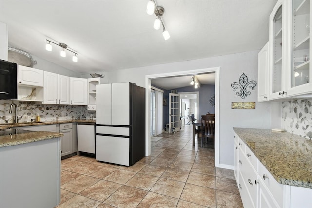 kitchen with white cabinetry, light stone counters, vaulted ceiling, dishwasher, and white fridge