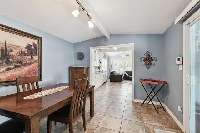 tiled dining area with vaulted ceiling with beams, rail lighting, and ceiling fan