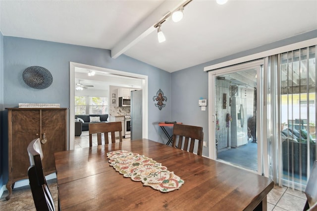 tiled dining space with lofted ceiling with beams