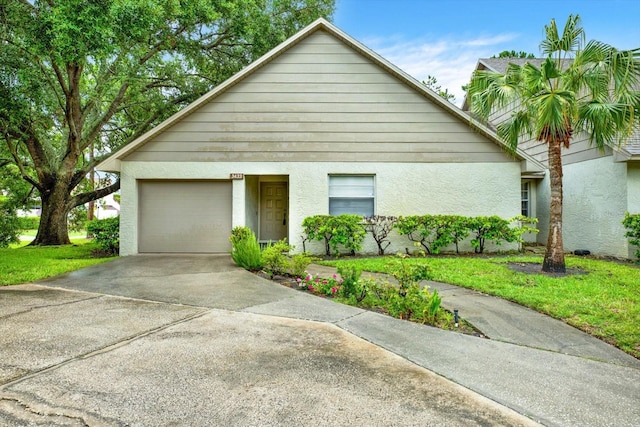 view of front of home with a garage and a front lawn