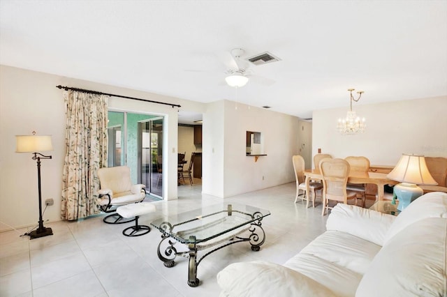 living room with ceiling fan with notable chandelier and light tile patterned floors