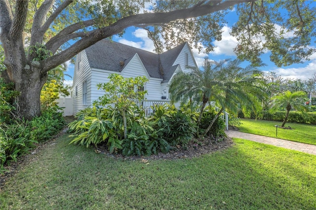 view of side of home with a yard