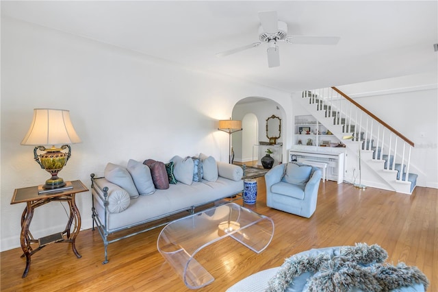 living room featuring hardwood / wood-style flooring and ceiling fan