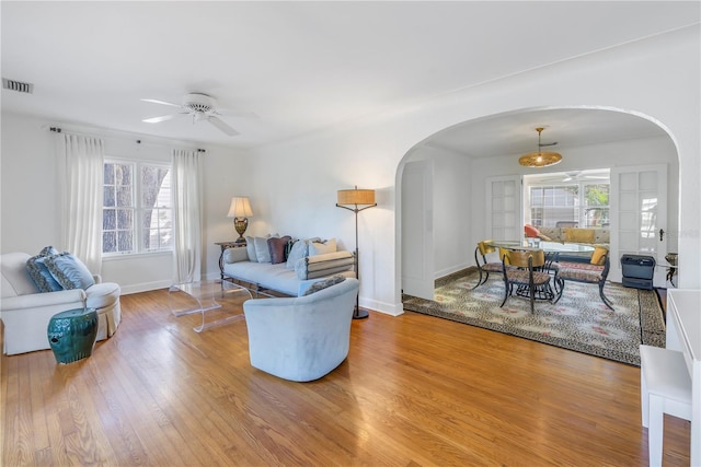 living room with hardwood / wood-style flooring and ceiling fan