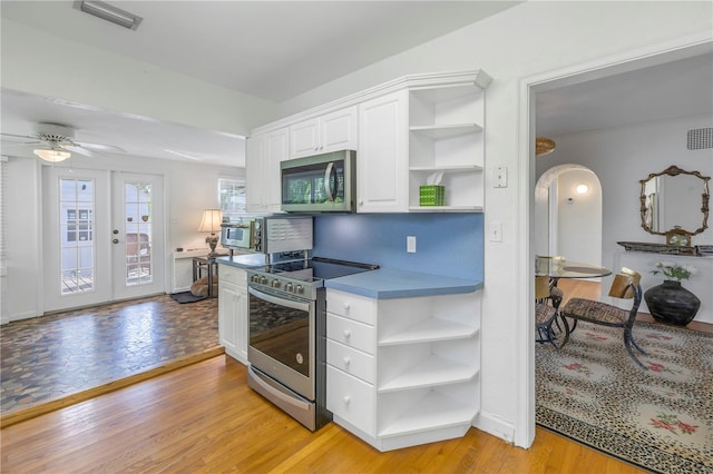 kitchen with white cabinetry, light hardwood / wood-style flooring, stainless steel appliances, and french doors