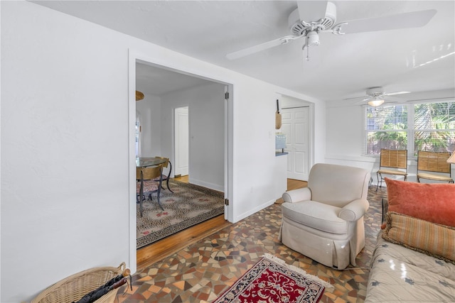 living area featuring ceiling fan