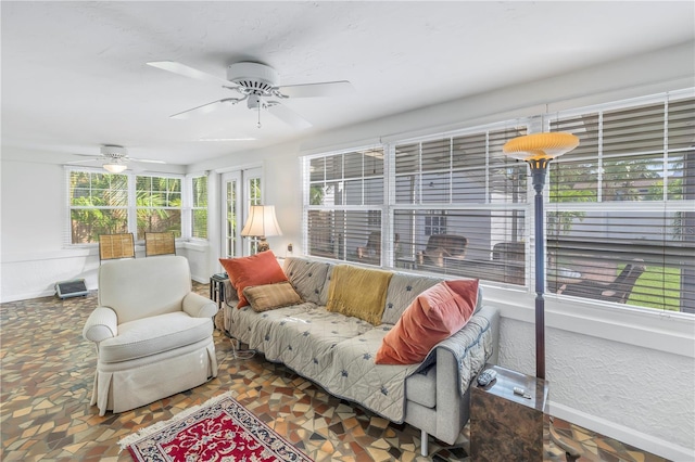 sunroom featuring ceiling fan