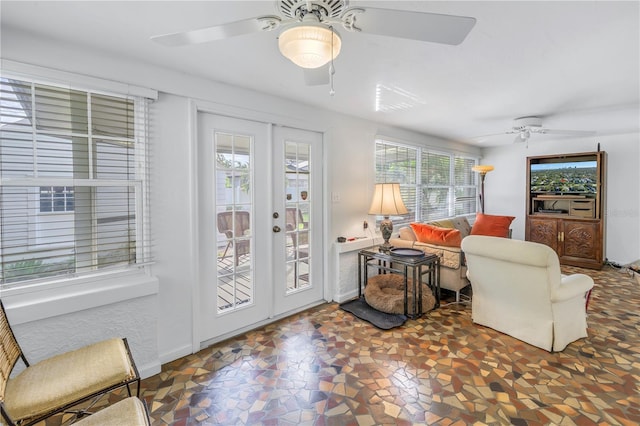 living area featuring ceiling fan and french doors