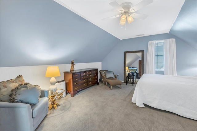 bedroom with ceiling fan, light colored carpet, and vaulted ceiling