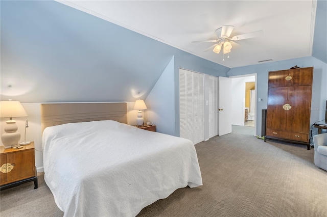 bedroom featuring lofted ceiling, light carpet, a closet, and ceiling fan