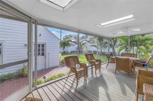 sunroom with ceiling fan and a skylight