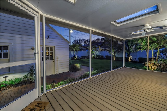 unfurnished sunroom with ceiling fan