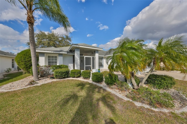 view of front of property with a sunroom and a front yard