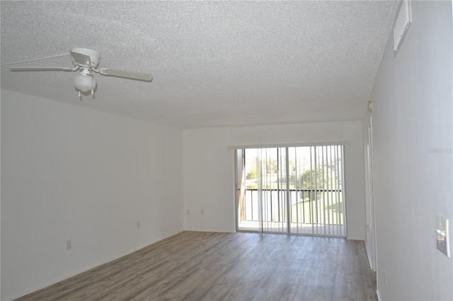 spare room featuring a ceiling fan, a textured ceiling, and wood finished floors