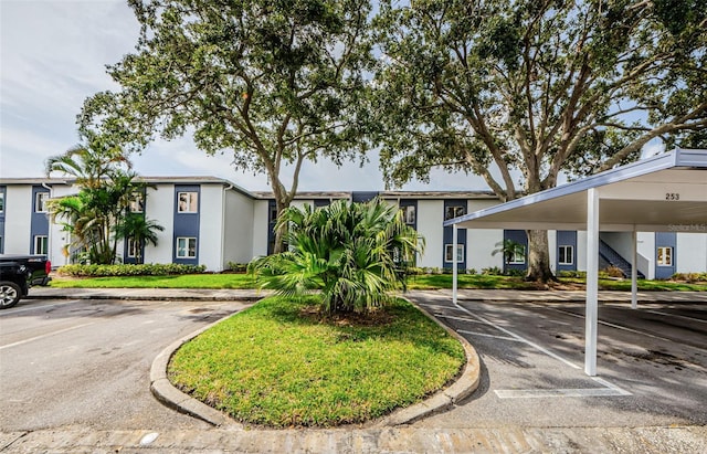 256 Cypress Ln Unit 120, Oldsmar, FL 34677 - view of front of property with covered and uncovered parking and stucco siding