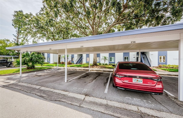 256 Cypress Ln Unit 120, Oldsmar, FL 34677 - covered parking lot featuring stairs