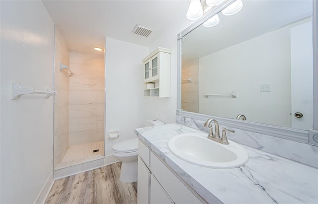 256 Cypress Ln Unit 120, Oldsmar, FL 34677 - bathroom with toilet, vanity, a stall shower, wood finished floors, and recessed lighting