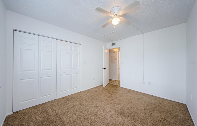 256 Cypress Ln Unit 120, Oldsmar, FL 34677 - unfurnished bedroom with carpet floors, a closet, a textured ceiling, ceiling fan, and baseboards