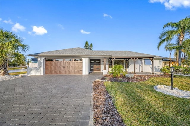 view of front of property featuring a garage and a front yard