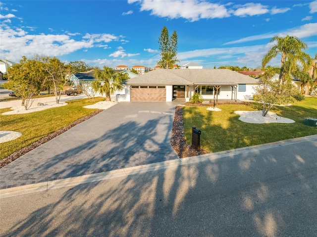 ranch-style house featuring a garage and a front yard