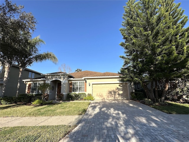 single story home featuring a garage and a front lawn