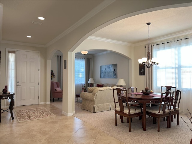 tiled dining space with ornamental molding and a chandelier