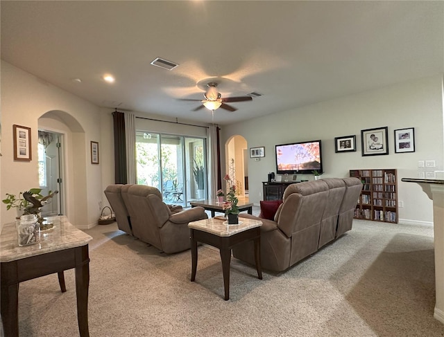 carpeted living room with ceiling fan