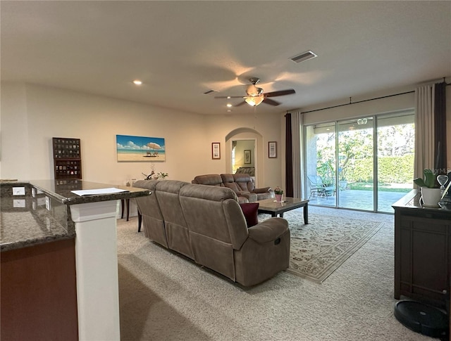 carpeted living room featuring ceiling fan