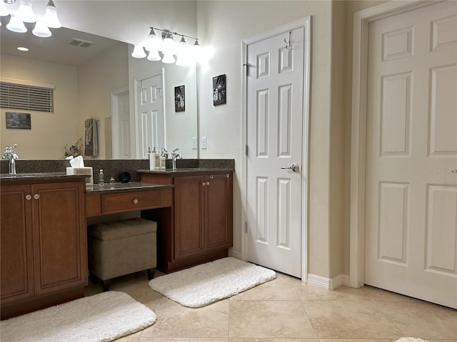 bathroom with tile patterned flooring and vanity