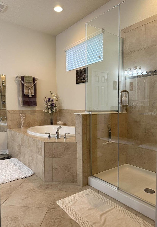 bathroom with tile patterned flooring and shower with separate bathtub