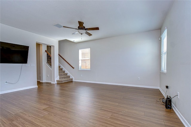 unfurnished living room featuring hardwood / wood-style floors and ceiling fan