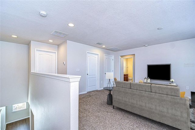 carpeted living room with a textured ceiling