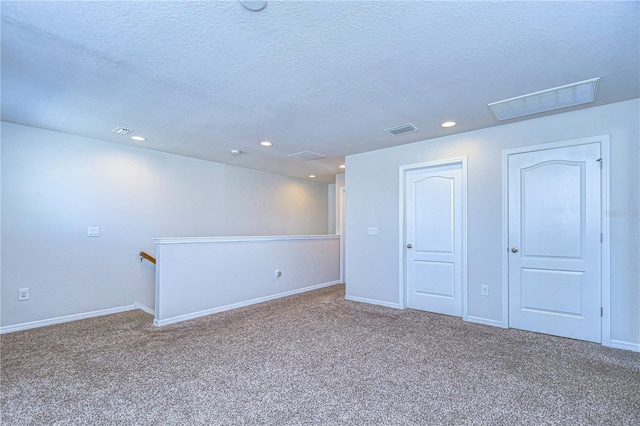 basement featuring carpet floors and a textured ceiling